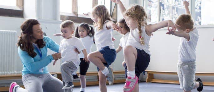 Teacher supporting students during a PE lesson