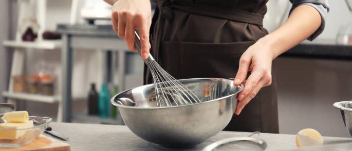 A woman whisking cake batter