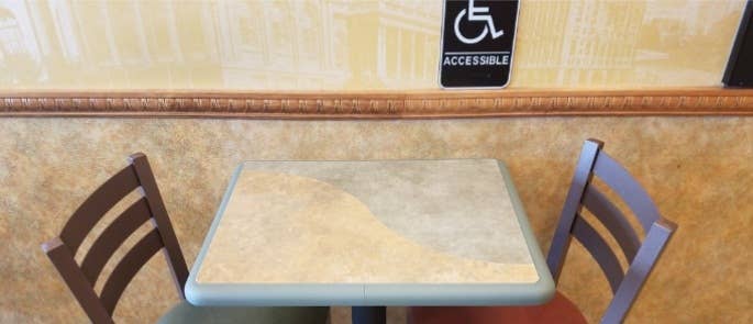 Accessibility sign above a restaurant table