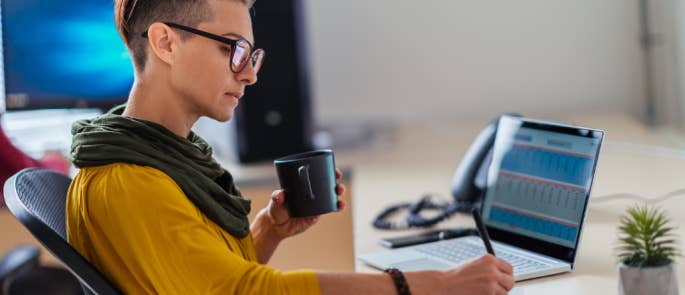 Businesswoman writing notes in the office