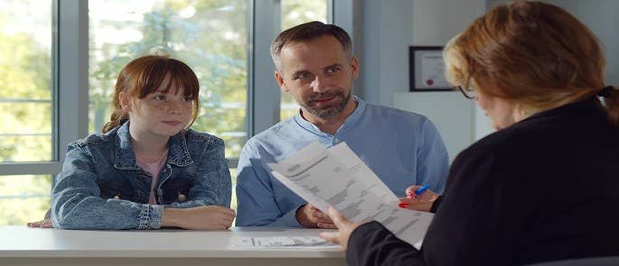 Teacher discussing a healthcare plan with pupil and parent