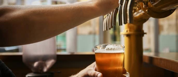 Bar worker pouring a beer