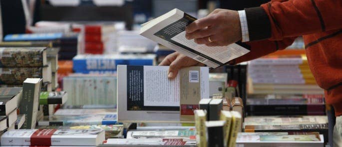 Someone looking through literature to read in a bookshop