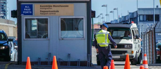 Man checking passports at Border Control at docks