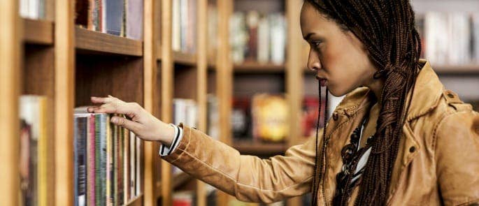 A woman choosing poetry in a bookshop