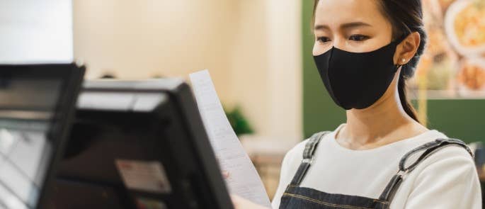 Cafe worker wearing a face covering