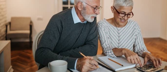 Carer assisting with an elderly man's bills