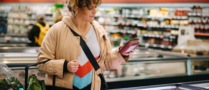 Shopper reading food item labels