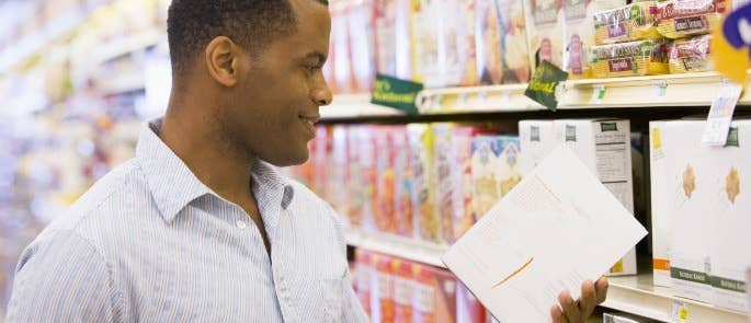 Man checking a food nutritional label in the supermarket