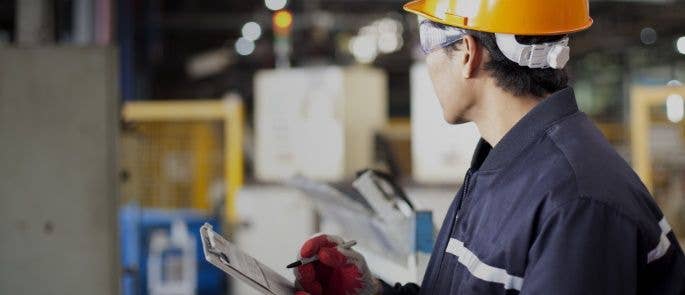 Worker reviewing assessment checklist