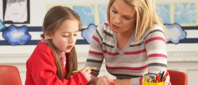 Teacher helping student with classwork