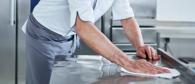 Man cleaning kitchen surfaces