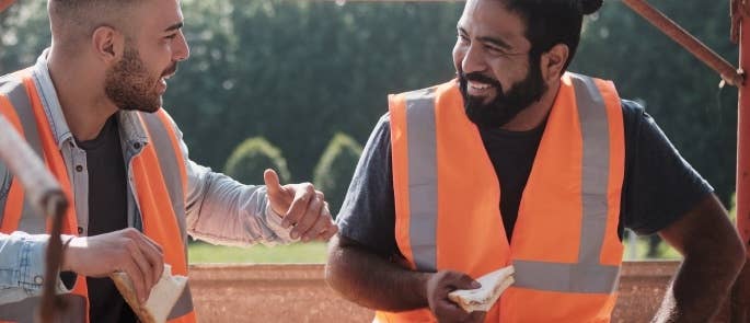 Construction workers talking and having lunch