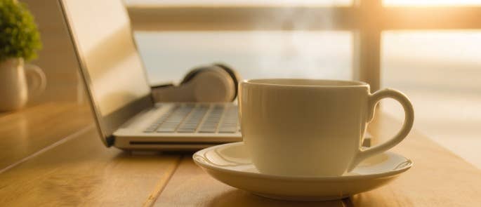 Cup of tea and laptop at home working desk