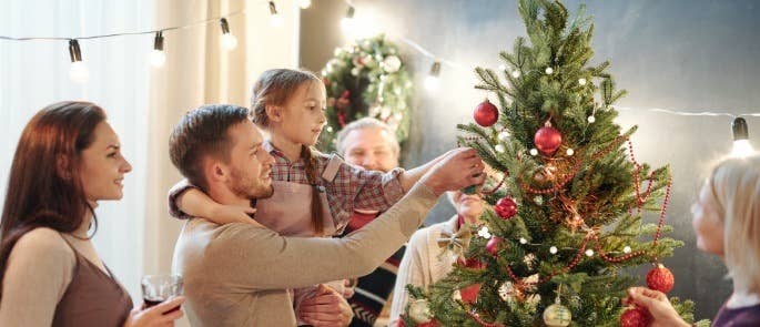 Family decorating a christmas tree together