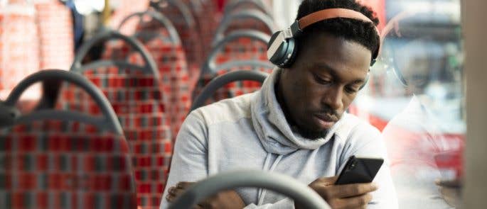 Man completing e-learning while on a bus