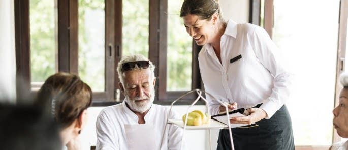 Man talking to waitress about menu