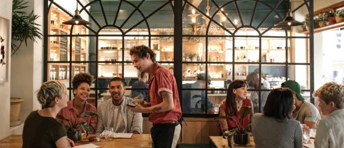 Waiter taking order in cafe