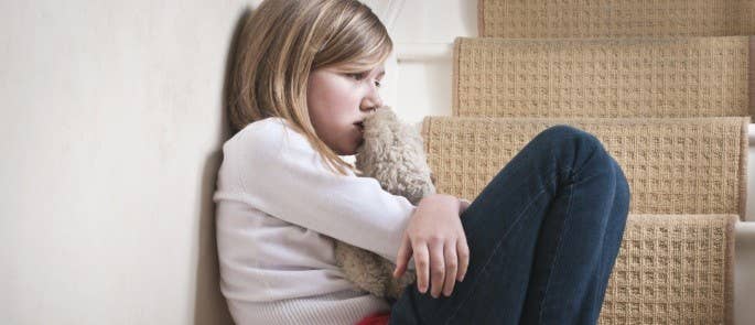 Emotional child sat on stairs