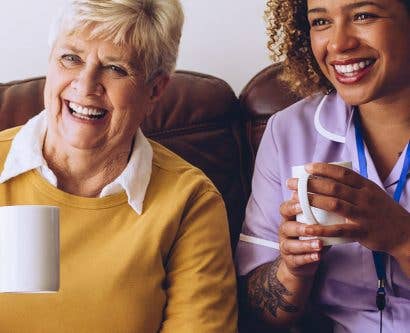 carer having cup of tea with service user and friend