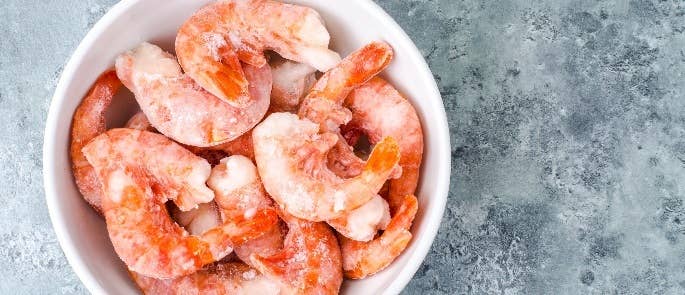 Bowl of frozen prawns