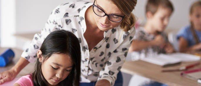 teacher helping a student