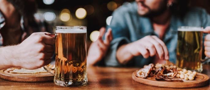 Guys at a pub enjoying food and drink