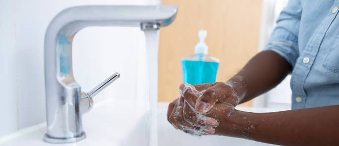 Boy washing his hands at home