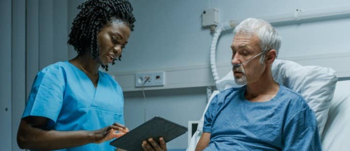 Nurse fulfilling her duty of care towards a patient in hospital