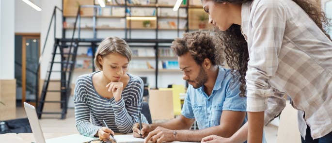 Three people working together as a team