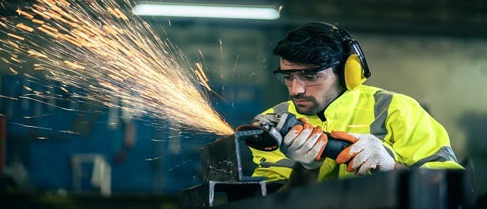 A grinding tool being used with the proper PPE