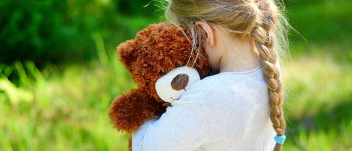 Little girl holding a teddy bear