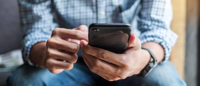 Close up of man's hands holding a phone