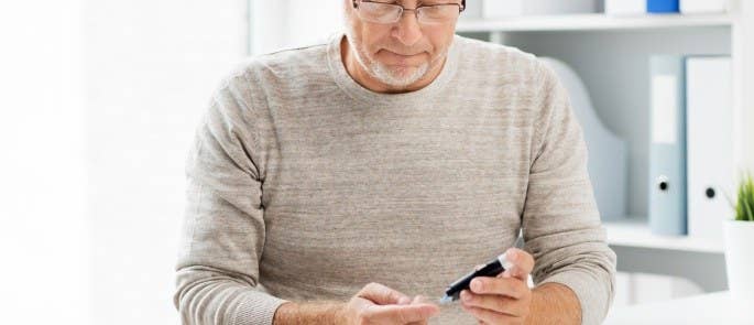 Man with diabetes testing his glucose levels at work