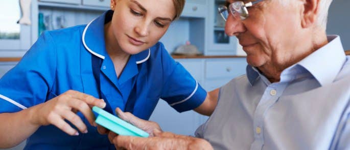 A healthcare professional helping an elderly person