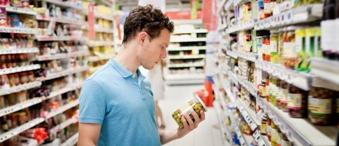 Shopper checking the nutritional information before purchasing a food product