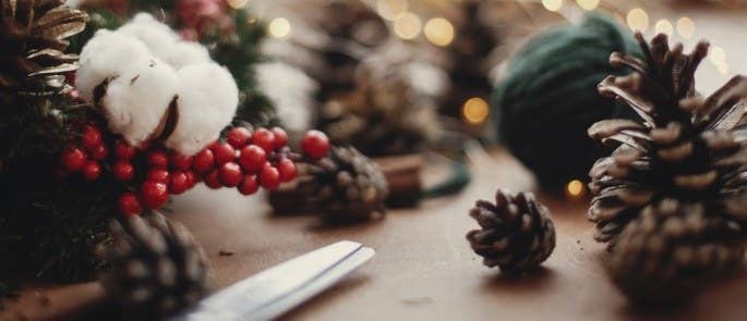 pinecones with scissors and string to make decorations