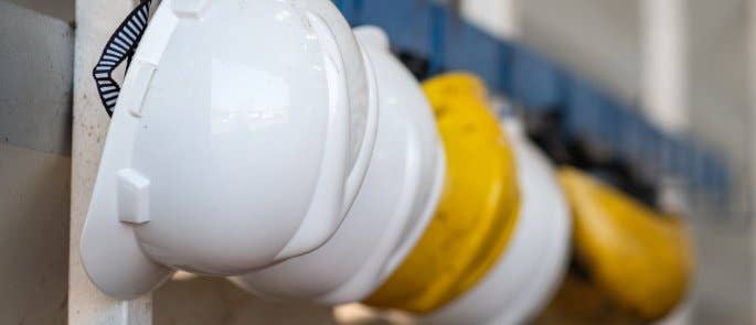 PPE hard hats hanging up in a workplace