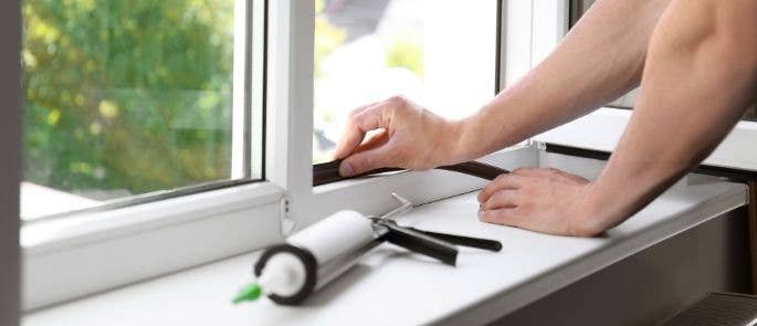 Repairman fixing window seal