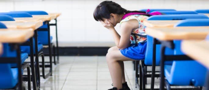 Upset child alone in classroom