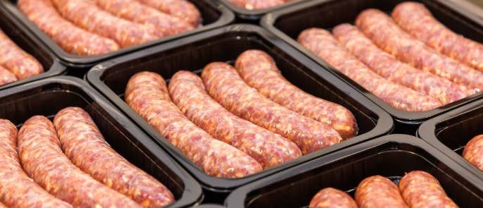 Boxes of sausages in a food manufacturing warehouse