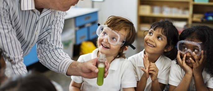 Three primary school children in a science lesson