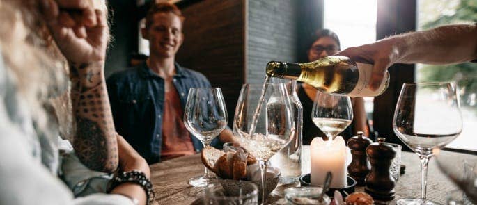 Waitress serving wine to a table