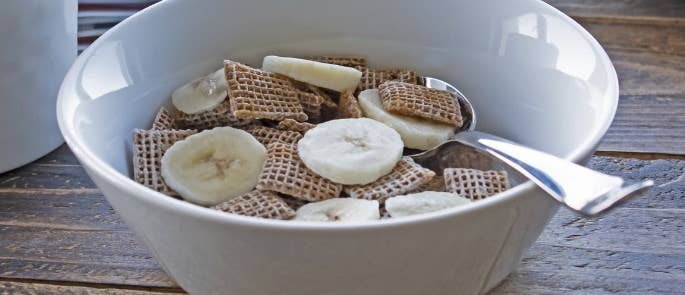 A bowl of cereal and fruit at a breakfast club