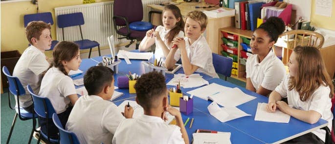 Students sat round a table discussing sensitive issues