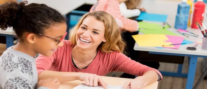 Teacher helping a pupil with her work