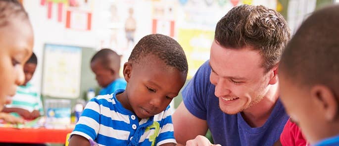 Teacher helping a child with their writing