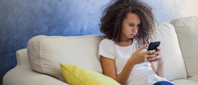 Teenager in a living room on her phone