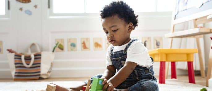 Young boy playing with toy train