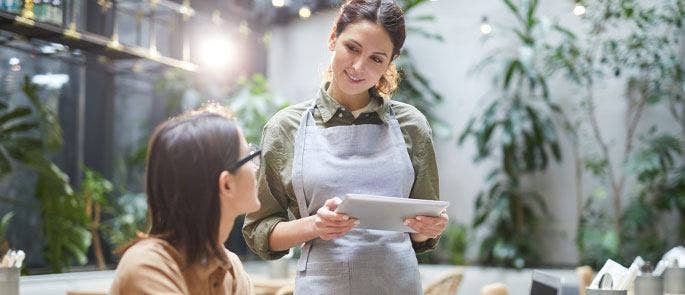 A waitress taking a food order from a customer